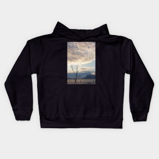 Dead tree in muddy beach Kids Hoodie